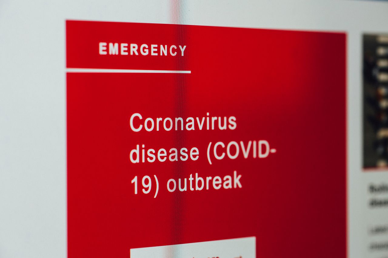 services-03 Close-up of a COVID-19 emergency alert message on a digital screen.